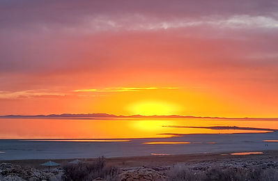 Orange and pink sunset reflected across calm water