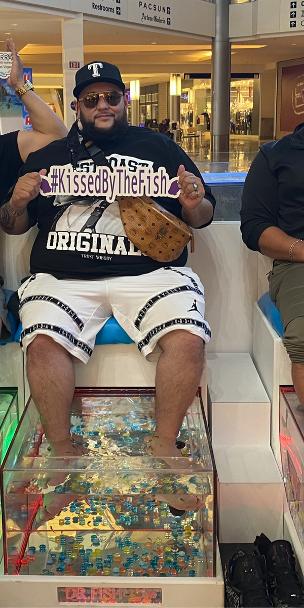 Happy guest enjoying the Dr. Fish Spa experience