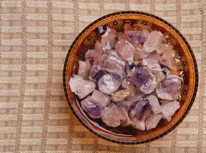 A picture of crystals in a water bowl at McQueen Massage Studio.