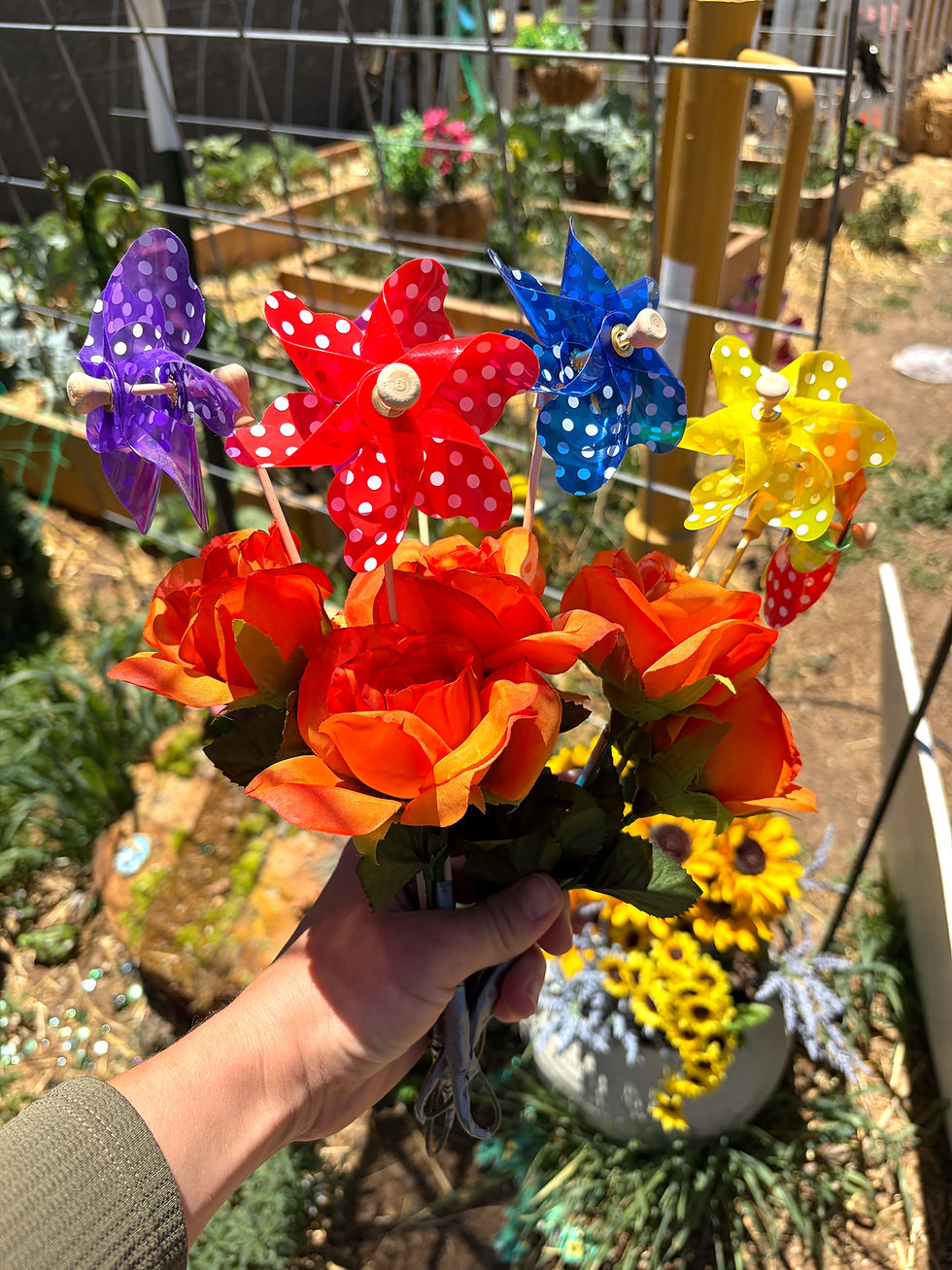 Close-up view of a colorful regulation bouquet made with fake flowers and a small windmill