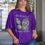 Thumbnail: Woman wearing the Beauty of Transformation Floral T-shirt in purple