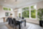 Dining room, kitche table, leather chairs, windows, area rug, indoor plant