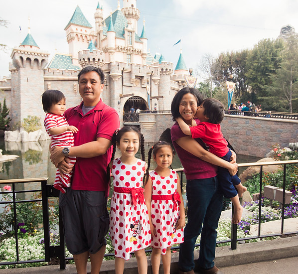 Rowena with family and kids in front of the Disneyland castle
