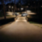 Outdoor driveway and street lighting installed by Water Worx illuminating private road and parking area at night