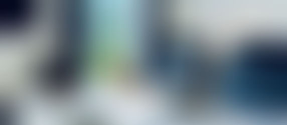 a golden retriever sits patiently, looking out over the patio, while being kept from running away by the retractable gate