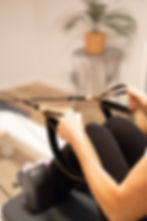 photo of hands holding the straps of a reformer