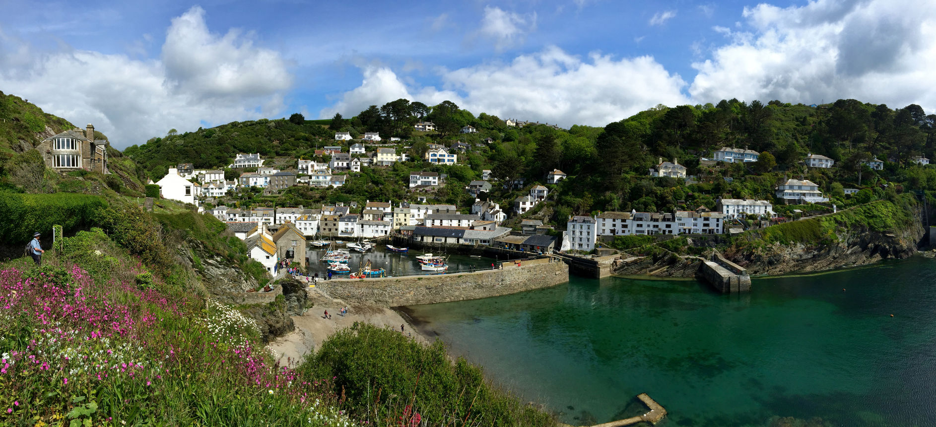 View of Polperro, the harbour wall and the village beyond.