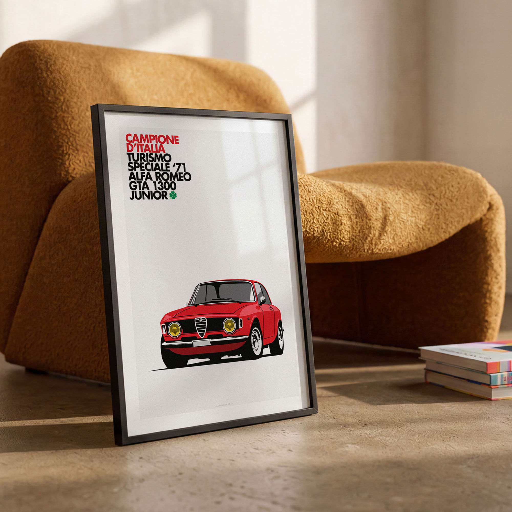 Black framed Alfa Romeo GTA 1300 Junior minimalist art print leaning against a modern arm chair