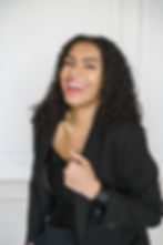 Dark haired woman smiling at camera.