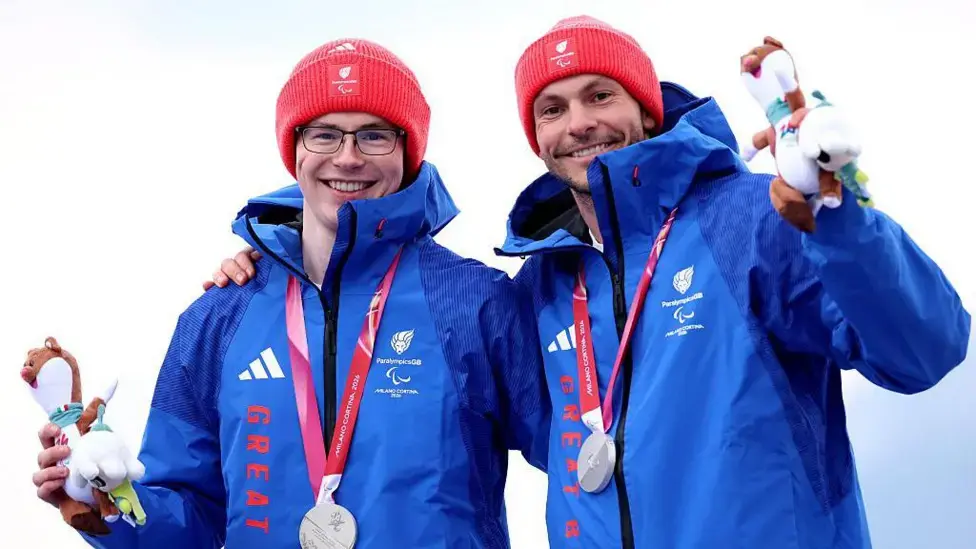 Neil Simpson (left) and his guide Rob Poth (right) have won Great Britain's first medal of the 2026 Winter Paralympics