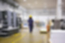 african-american-female-industrial-employee-hardhat-overall-walking-plant-floor.jpg