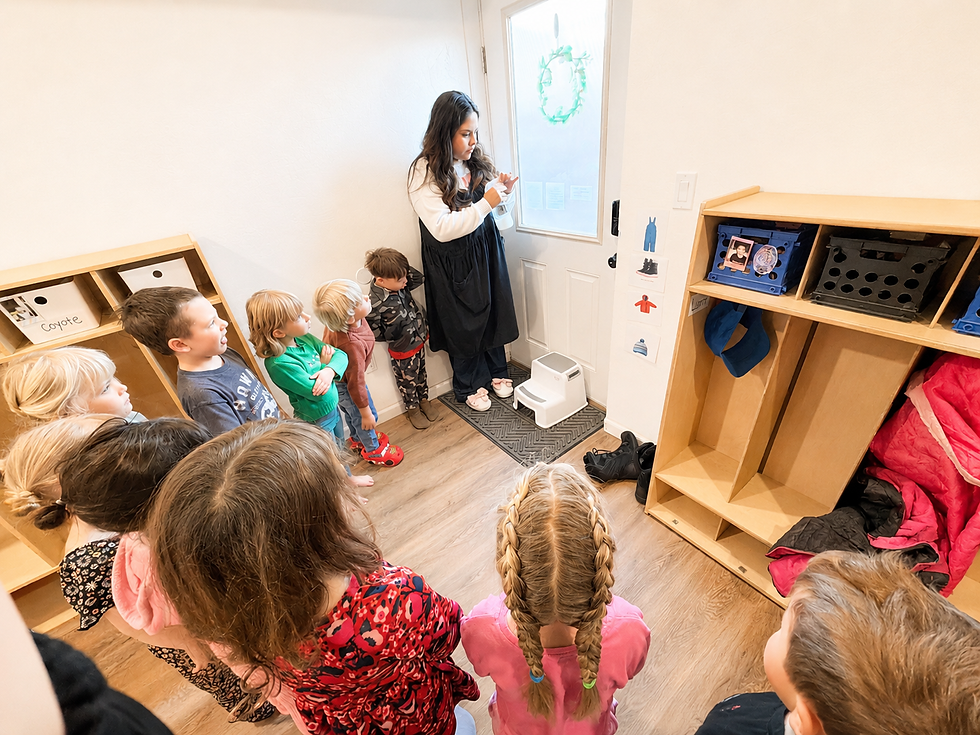 Little Blooms Montessori School - Certified Montessori Teacher explaining how to clean windows for life education - Sandy, Utah