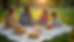High angle view of a family picnic setup in a sunny park with blankets, food, and toys