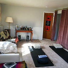Hugh's home healing space with mats laid out for a ketamine assisted group session with an altar in the background
