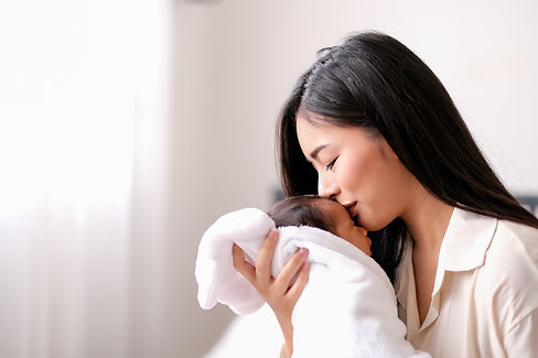 white-shirt-asian-mother-is-kissing-at-forehead-of-2022-01-19-00-20-27-utc.jpg