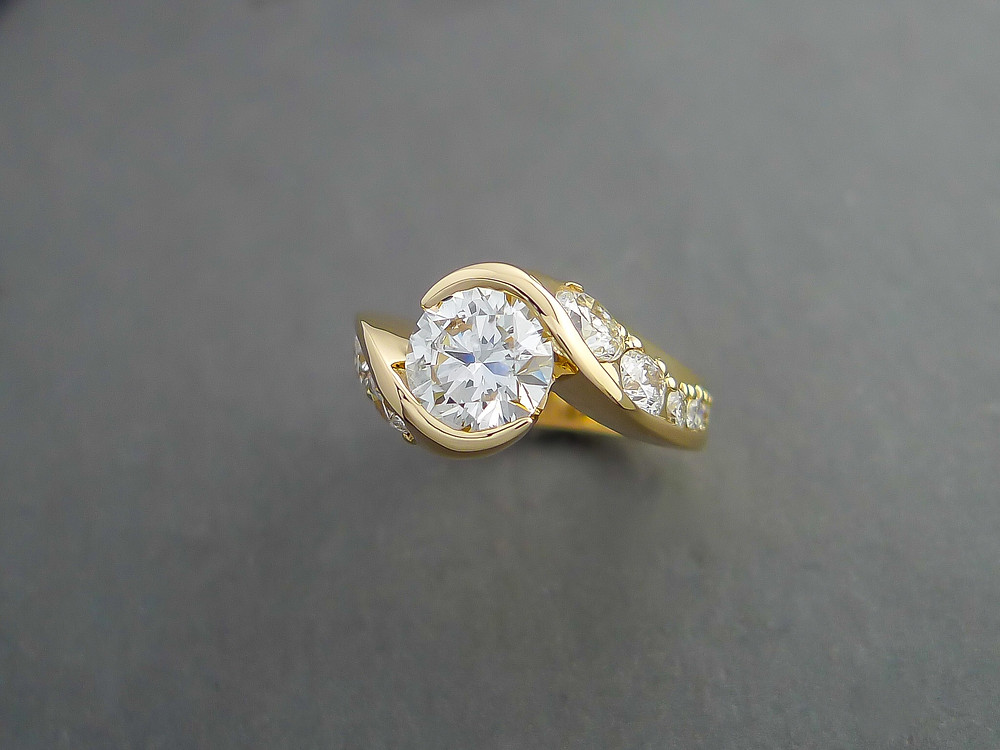 14K yellow gold ring set with one 2.00 carat diamond in the center; accompanied by ten diamonds with a total weight of 1.50 carat.