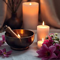 Soft, subdued and beautiful — candles, a single sound healing bowl, flowers.jpg
