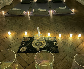 Workplace sound bath set up with bowls and LED candles