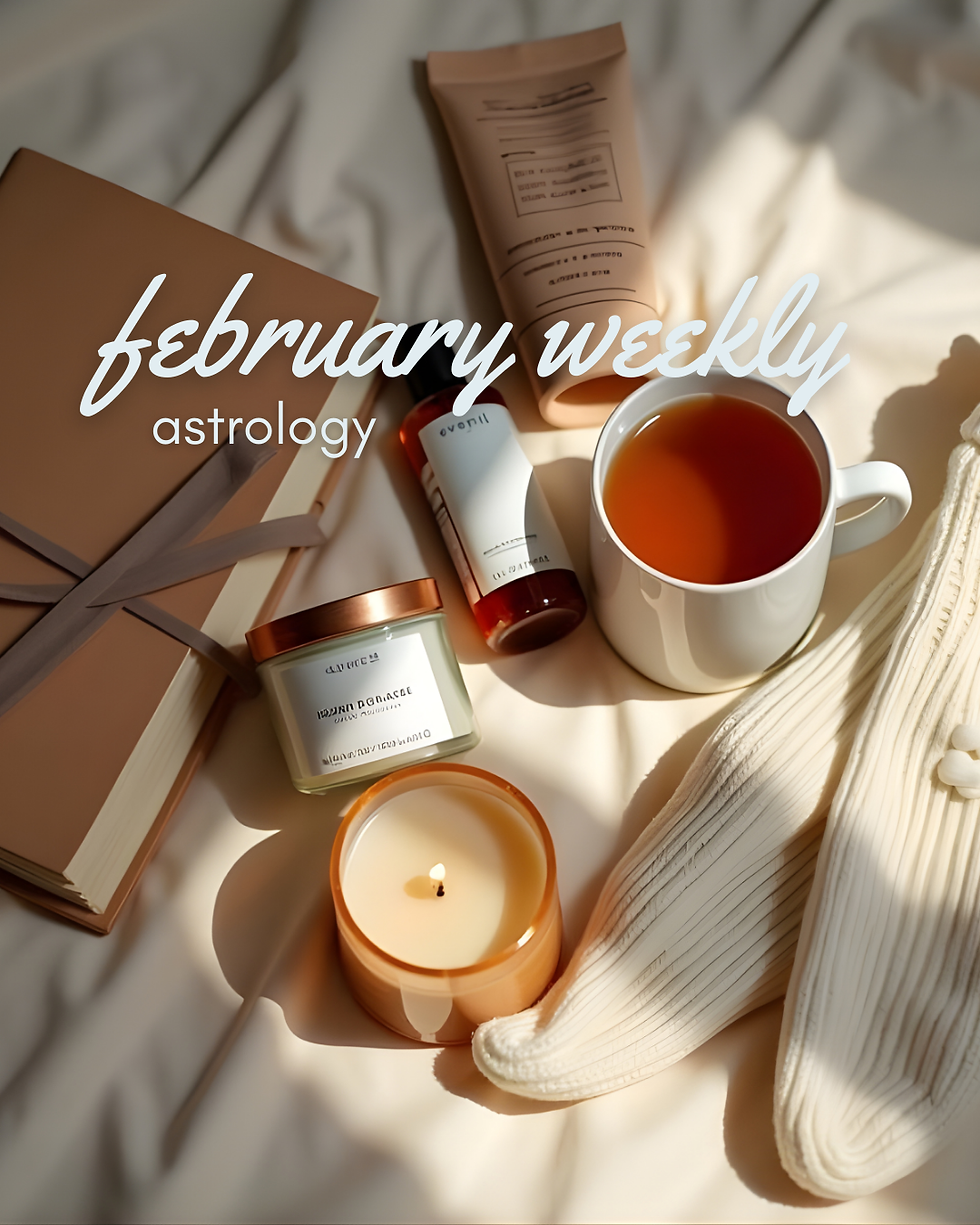 Warm toned flat lay with journal, lit candle, tea cup, skincare items, and text that reads February weekly astrology.