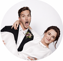 Playful wedding couple posing inside a circular frame, with the groom reacting in surprise and the bride smiling, captured in a clean studio-style photo booth portrait.
