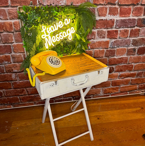 Retro Yellow Audio Guestbook Phone on antique suitcase with green wall back
