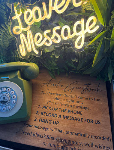 Audio guestbook sign shown on wood in suitcase table