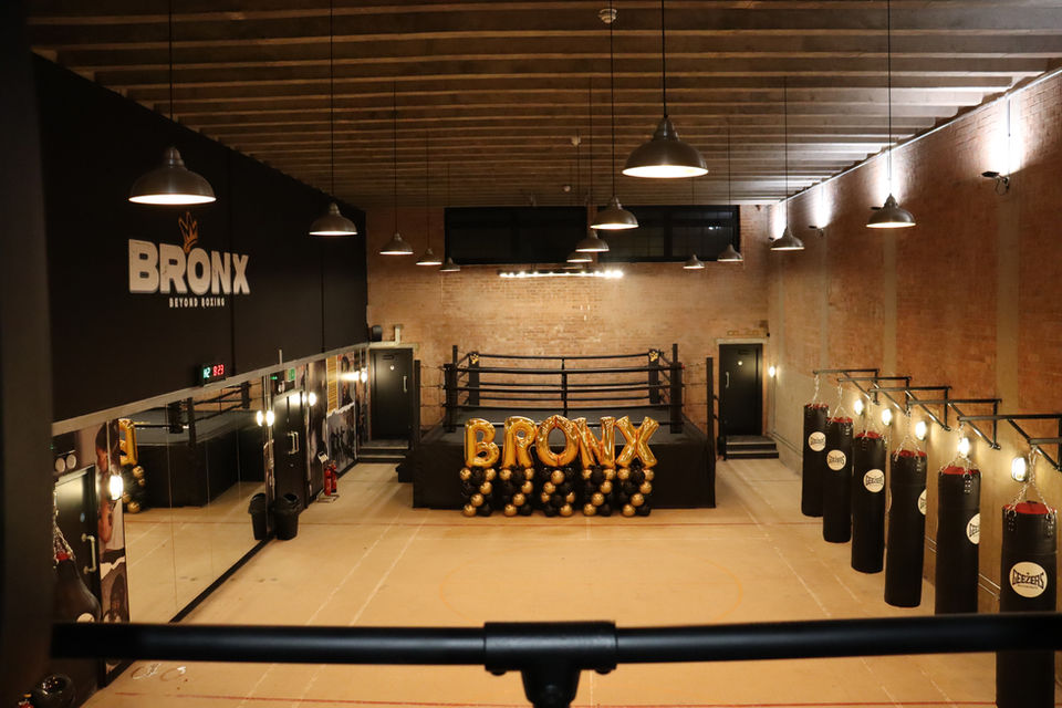 bronx boxing ring with golden balloons celebrating the recent launch 