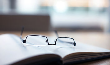 Glasses on open book