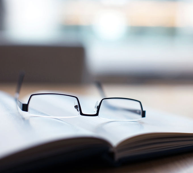 Glasses on open book