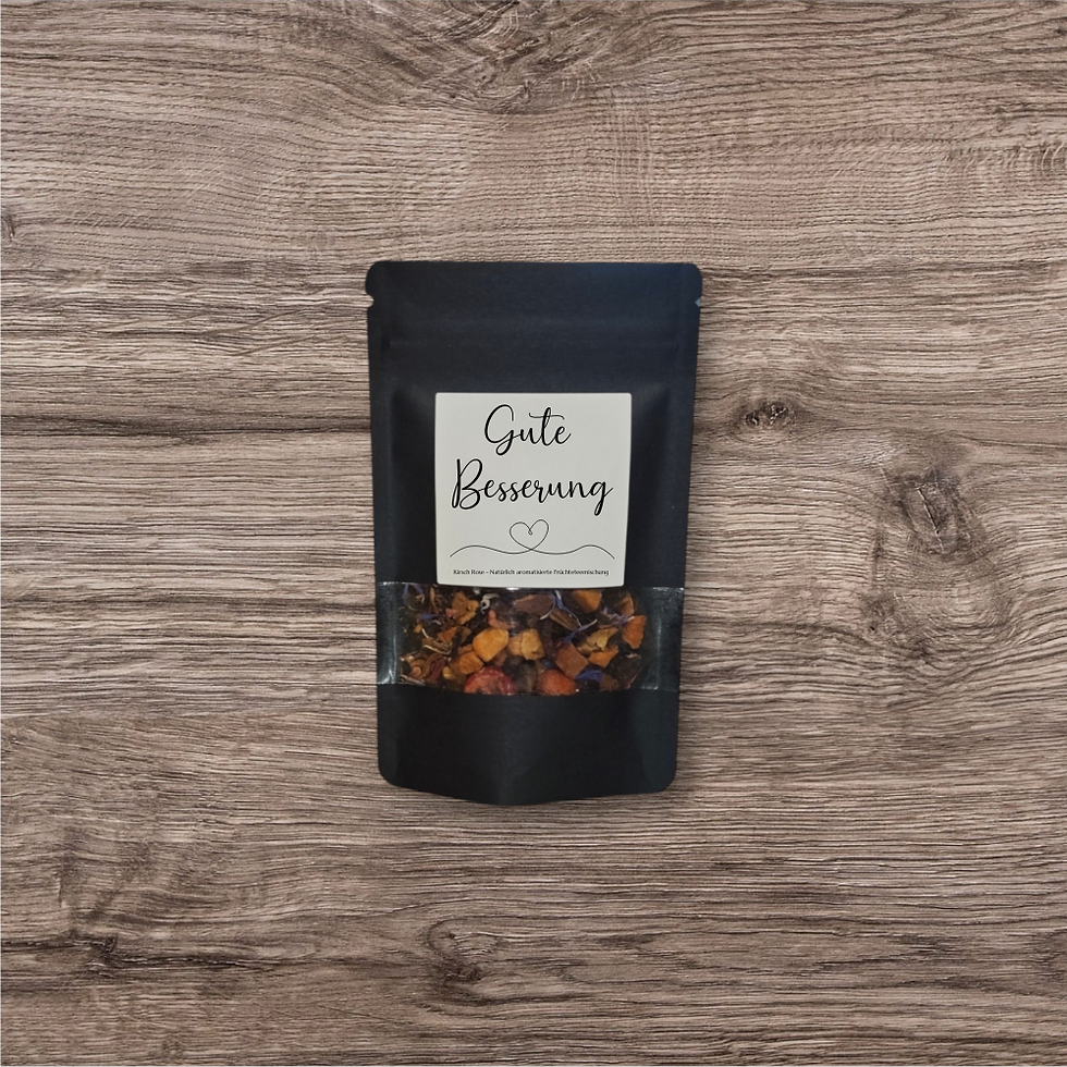 Tee in einer schwarzen, stehenden Verpackung mit Sichtfenster und Aufdruck "Gute Besserung" 