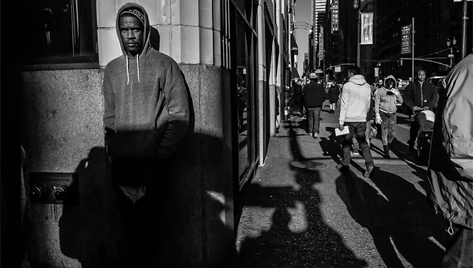 How can anyone not want to get rid, and by means without appeal, of someone who is fundamentally a “criminal”, essentially a “danger”, and naturally a “monster”. The safety of all of us is at stake. - Foucault , The Proper Use of Criminals Foreword Alterity Series is a set of articles that strive to understand the phenomenon of alterity from a socio-anthropological perspective. The subsequent six articles will embark on a definition of Alterity and its power dynamics; it will also enable the reader to understand how alterity takes form under societal institutions by using the example of prisons. In a world that is disoriented towards the Other, we must ask ourselves which representations have been ingrained in the population and if these representations originate from dominant mechanisms. Alterity Series is divided into six different chapters: 1. Alterity Series: Alterity as the Landmark of the Occident   2. Alterity Series: The Power of Alterity 3. Alterity Series: The Alarmist Discourse 4. Alterity Series: Social Institutions as a Solution for Separating the Other from Society 5. Alterity Series: Hyper-Incarceration 6. Alterity Series: The Development of a Status: Becoming a Prisoner The Alarmist Discourse We have understood the concept of alterity and the power it can have in societies. Now, in the multitude of Others that exist in the Occident, a specific one has to be discerned in order to have a concrete example of the Alterity process condemning the Other. The present article will exemplify Alterity by using the case of the delinquent Other. Around the 1970s there was a shift in the way the media perceived crime: it changed from being localized and specified to being atmospheric, dispersing throughout society (Garland, 2001). Today, the population obsesses over the possibility of being a victim of a criminal act; individuals think that society is full of delinquents who will rob, rape, or even murder them; people are terrified of the delinquency of Others. Representations of those delinquents are present everywhere in Western culture, but especially in literature. For instance, crime novels reveal the delinquent as a stranger to this world, with no connection whatsoever to the familial experiences and daily life of individuals in society (Foucault, 1975). This foreignness that was previously attributed to the madman, the vagabond, and the beggar, is now attributed to the delinquent. The literature about police inquiries recounts a delinquent which reflects a near far-away, i.e. the original environment of the delinquent seems far and stranger but paradoxically his existence is closer than what we think (Foucault, 1975). If it is true that the criminal persona in literature has sometimes been heroized, it is also true that criminality has constantly been identified as a threat to the social corpus, which has contributed to the construction of a hyper-consciousness of crime (Foucault, 1978). These representations in culture will have an influence on the citizens' feelings of insecurity, an alarmist discourse then emerges, arguing that the contemporary world is a dangerous world and that a criminal act could take place at any time. Real insecurity and the feeling of insecurity  are not distinguished anymore, and the alarmist discourse makes citizens feel insecure, even if real danger is not present. Figure 1: Representation of a possible street delinquent The alarmist discourse is not solely about insecurity. In fact, the discourse of insecurity must be directed to an object of fear in order to become an othering discourse. Most often this target is the street delinquent coming from poor neighborhoods or the immigrant - he is the dangerous one that must not be encountered (Wacquant, 2008). The term ‘dangerous’ itself came into existence in 1859 to define the poor and the individuals receiving low-wage work, or the people which did not belong to the hegemony and who therefore were the ones who ought to be controlled (Bell, 2011). Today, the individuals considered dangerous are still the ones originating from the lowest societal classes or the ones from ethnic-racial minorities background. Because of that, an era of security has emerged that maintains a target population that must be controlled: the delinquents. The resulting collective fear of the alarmist discourse leads citizens to more easily accept the punishment an individual undergoes. They see the delinquent for what he is, rather than for what he has done. Politicians, media, and professional law enforcement insist on the insecurity of our societies and perpetuate the alarmist discourse (Wacquant, 2008). Produced by private or state interests, the media is often image-centered and tells a story that is supposed to come from reality (Appadurai, 1990). Yet as a producer of a narrative, what may be real becomes fiction, or narrative; individuals are transformed into characters and they begin to take on imaginary lives. The media helps to construct narratives about the Other and proto-narratives of their possible lives, fantasies, and movements (Appadurai, 1990). Television documentaries show the 'real' conditions of existence of these Others, and newspapers expose their dreams of modernity (Trouillot, 2003). The media have highly contributed to developing this process by giving more weight to delinquency than to other forms of illegality. They recount day by day a sort of interior conflict against the enemy  - the institutional alarm of a ‘he’ being next to us or a ‘he’ being defeated by the state. Xenophobia has emerged and has penetrated most western countries. This xenophobia can be seen in countries in which the extreme right is taking over the political scenery with discourses against minorities; for instance, among others, in The Netherlands with Thierry Baudet and its party Forum Voor Democratie; Italy with Matteo Salvini head of the Lega party; France with Marine Le Pen and her party Rassemblement National; or in the USA with Donal Trump as the former President, etc. The xenophobia portrayed by these political movements is increasingly diminishing the distinction between immigration, illegality, and criminality. The consequences of xenophobia will be real even if the discourses it portrays are false. For instance, law enforcement professionals will enable the condemning of an individual because he has a biography that is portrayed as dangerous by xenophobic discourses (Foucault, 1975).  The repressive forces will have the responsibility to identify the delinquents and restore the symbolic order of society (Wacquant, 2005), and the social norm is what will be used to identify delinquents and bring them before the law. In conclusion, the delinquents are identifiable through multiple representations (economic, political, or cultural), which shows coercive state apparatuses where to search. Alterity has gained power and the Other is identified in society so that he can be separated from it. The discourse, or the “lack of safety” that is urged creates a series of problematic neighborhoods and populations that will become the target of repressive authorities. The fragment of the population targeted by alterity will become the one to whom society attributes all its problems. Therefore, they become the scapegoats of society and will be treated as evil and as the ones who ought to be separated. An enemy within is created and repressive forces are used as a solution to keep the them separated from the Us. References Appadurai, A. 1990. « Disjuncture and Difference in the Global Cultural Economy ». Theory Culture Society  7(295):295‑310. doi: 10.1177/026327690007002017. Bell, E. 2011. Criminal Justice and Neoliberalism . Savoie, FR: Palgrave Macmillan. Foucault, M. 1975. Surveiller et punir : Naissance de la prison . Paris, FR: Éditions Gallimard. Foucault, M. 1978. « About the Concept of the “Dangerous Individual” in Nineteenth-Century Legal Psychiatry ». P. 176‑200 in Rabinow, P. Essential works of Foucault . Vol. 3 – Power. London, UK: Penguin. Garland, D. 2001. The Culture of Control . Chicago, USA: The University of Chicago Press. Trouillot, M. R. 2003. Global Transformations: Anthropology and the Modern World . New York, USA: Palgrave Macmillan. Wacquant, L. 2008. « Ordering Insecurity: Social Polarization and the Punitive Upsurge ». Radical Philosophy Review  11(1):9‑27. Wacquant, L. 2009. Prisons of Poverty . Minneapolis, MN: University of Minnesota Press. Images references Figure 1: Representation of a possible street delinquent. Digital Photography School. https://digital-photography-school.com/conquer-fear-street-photography/  Figure 2: Prejudice: black and white men. Tyonote. https://tyonote.com/prejudice/ Figure 3: Waters, G. Trump may be shifting social norms around xenophobia. Getty Creative Images. https://www.vox.com/science-and-health/2017/5/31/15714002/america-becoming-more-prejudiced-psychology