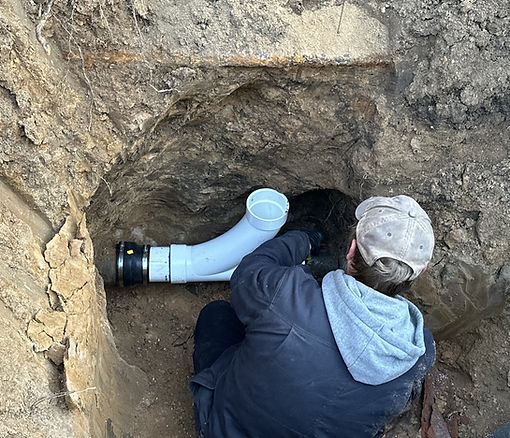 Professional installing a durable sewer line for a residential utility project.