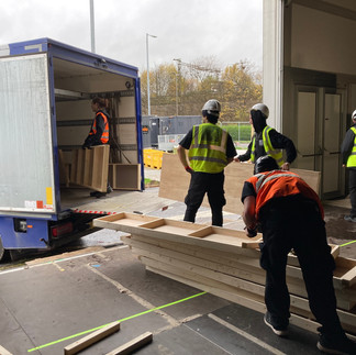 A group loading a van with materials