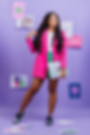 melissa-wildmelidesignstudio-branding-and-website-standing with a pink blazer and a green skirt, white tshirt and long hair, mackbook in hand and violet background