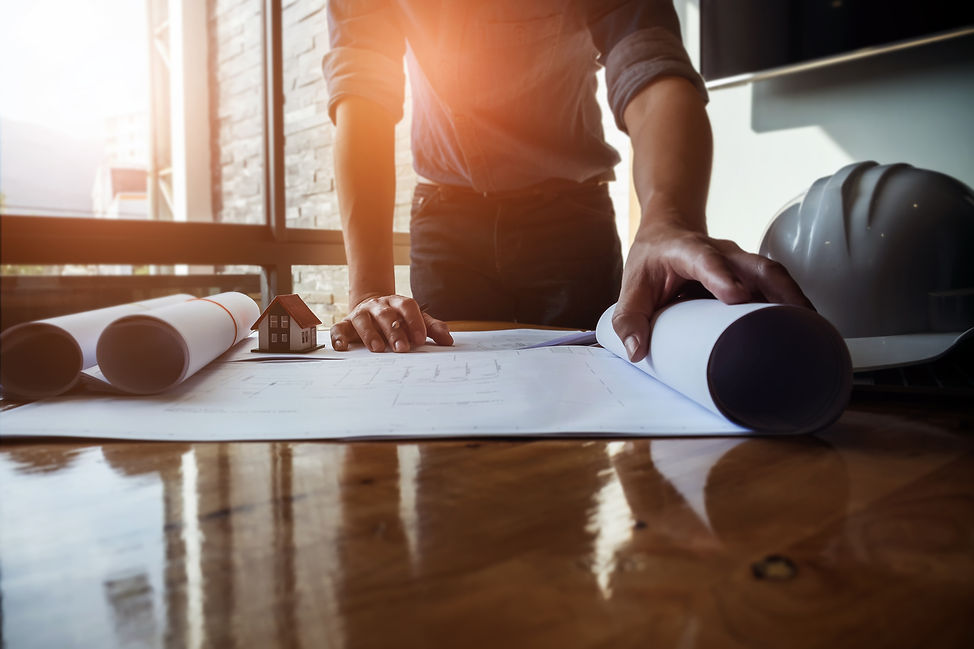 Architect design concept. Young engineer drawing of house structure on blueprint to presen