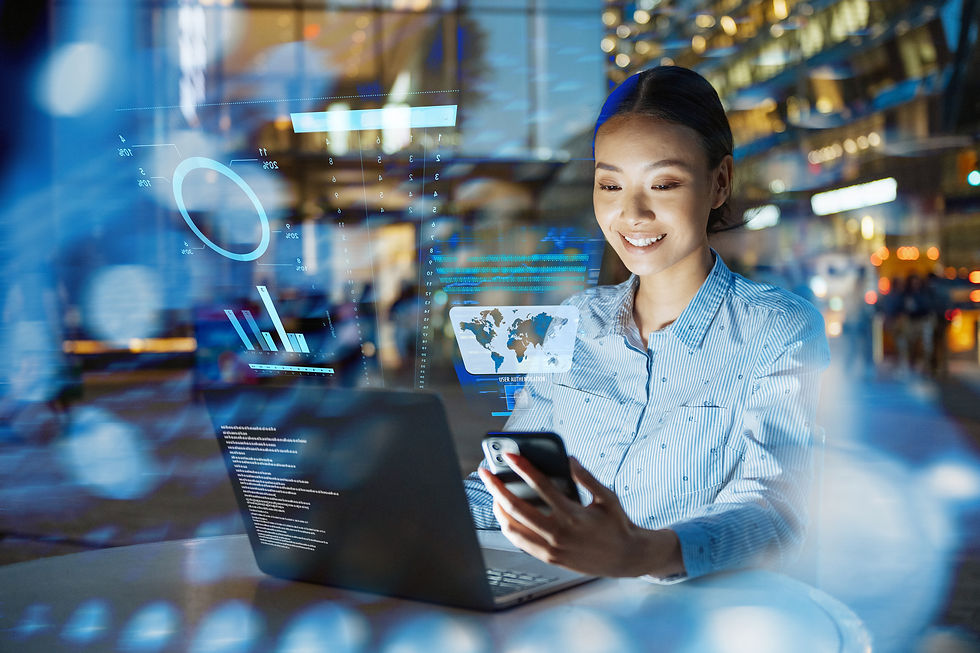 Business professional working on a laptop and smartphone with digital data visualisations overlaid, representing confident, intelligent application delivery and risk management.