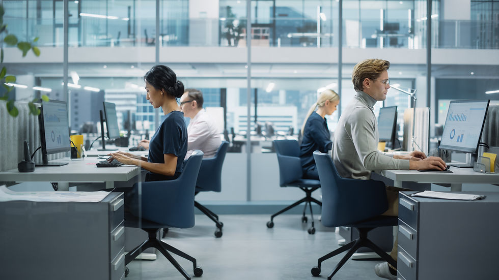 A group of office colleagues working at shared desks