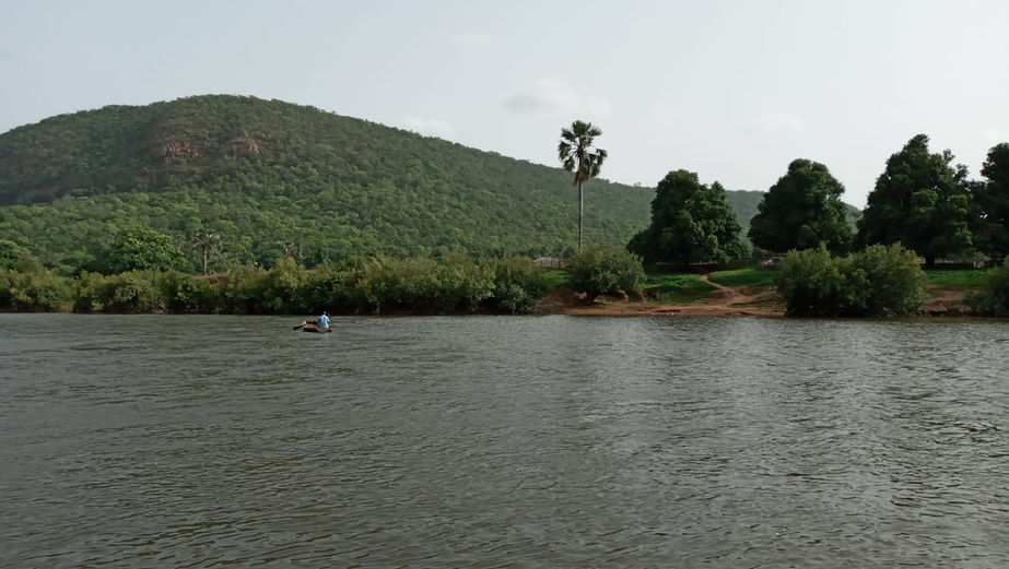 Scenic view of lush green mountain and Gambia River - Nature's beauty at its finest.