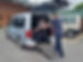 MS Centre customer in Wheelchair with Kev pushing in.jpeg