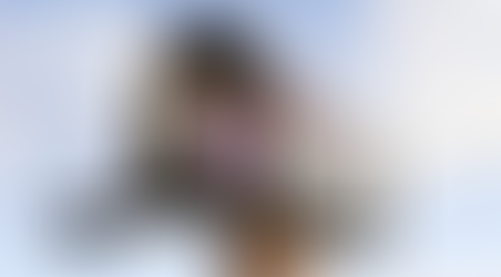 a mailbox with letters inside with a blue sky behind it.