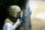 Worker Sandblasting Wall
