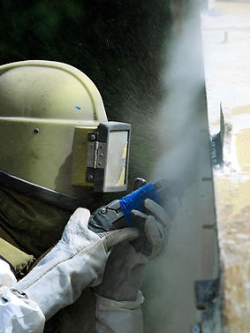 Worker Sandblasting Wall