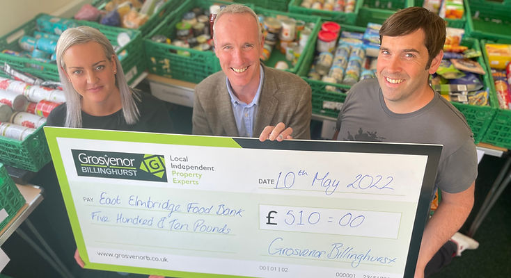 Chris Burton (centre) present East Elmbridge Foodbank with £510.jpg