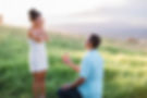 man proposing to woman in field