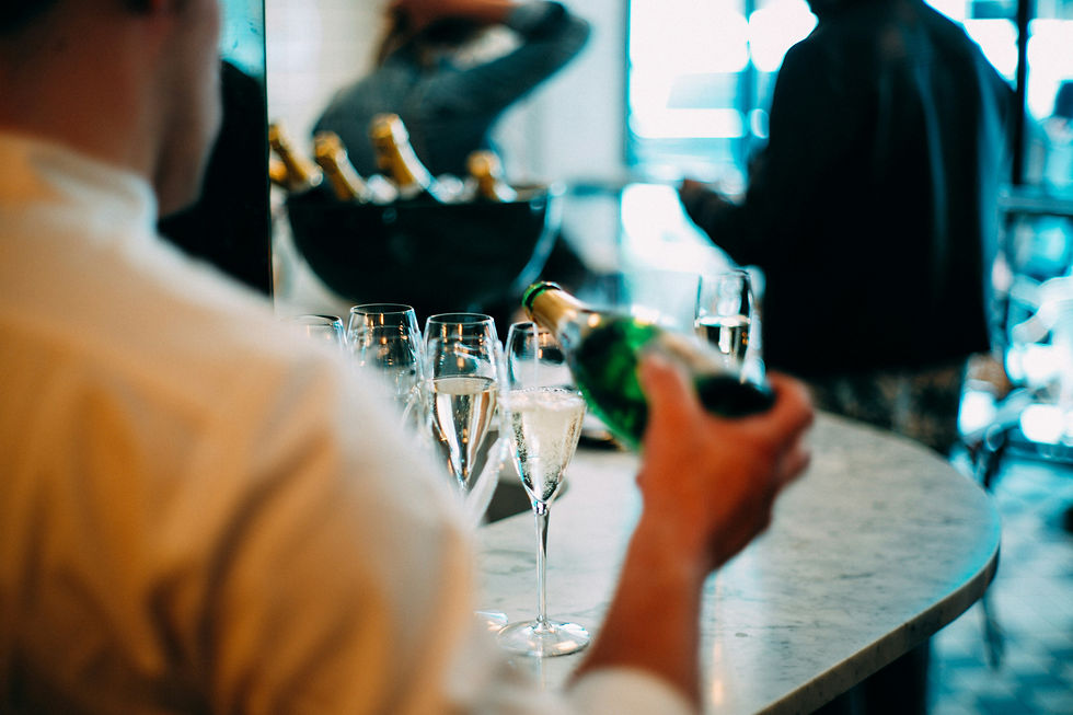 A waiter pouring champagne into the glass