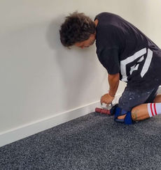 all flooring team member finishing garage carpet