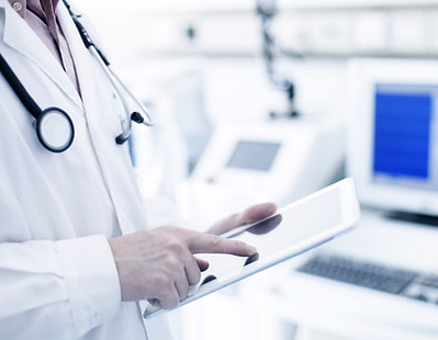 Doctor Using Digital Tablet