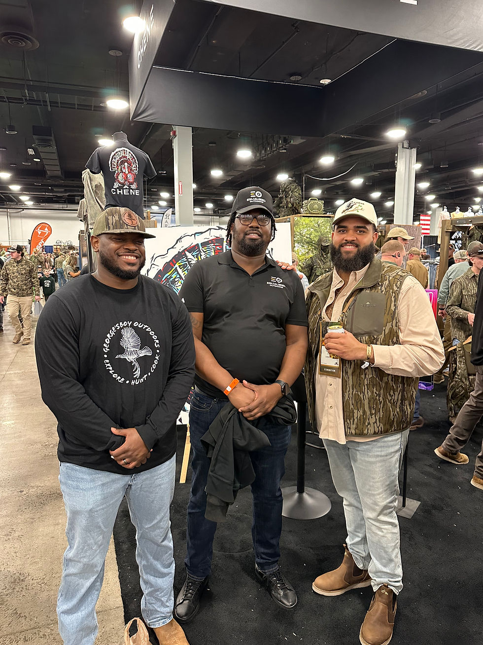 Three industry media members pose for a photo at the Chene Gear booth.