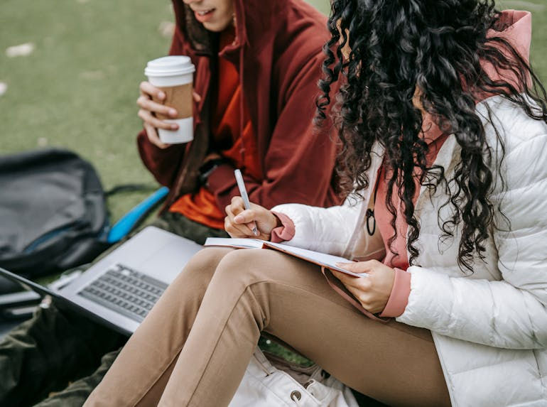 two people studying in a park