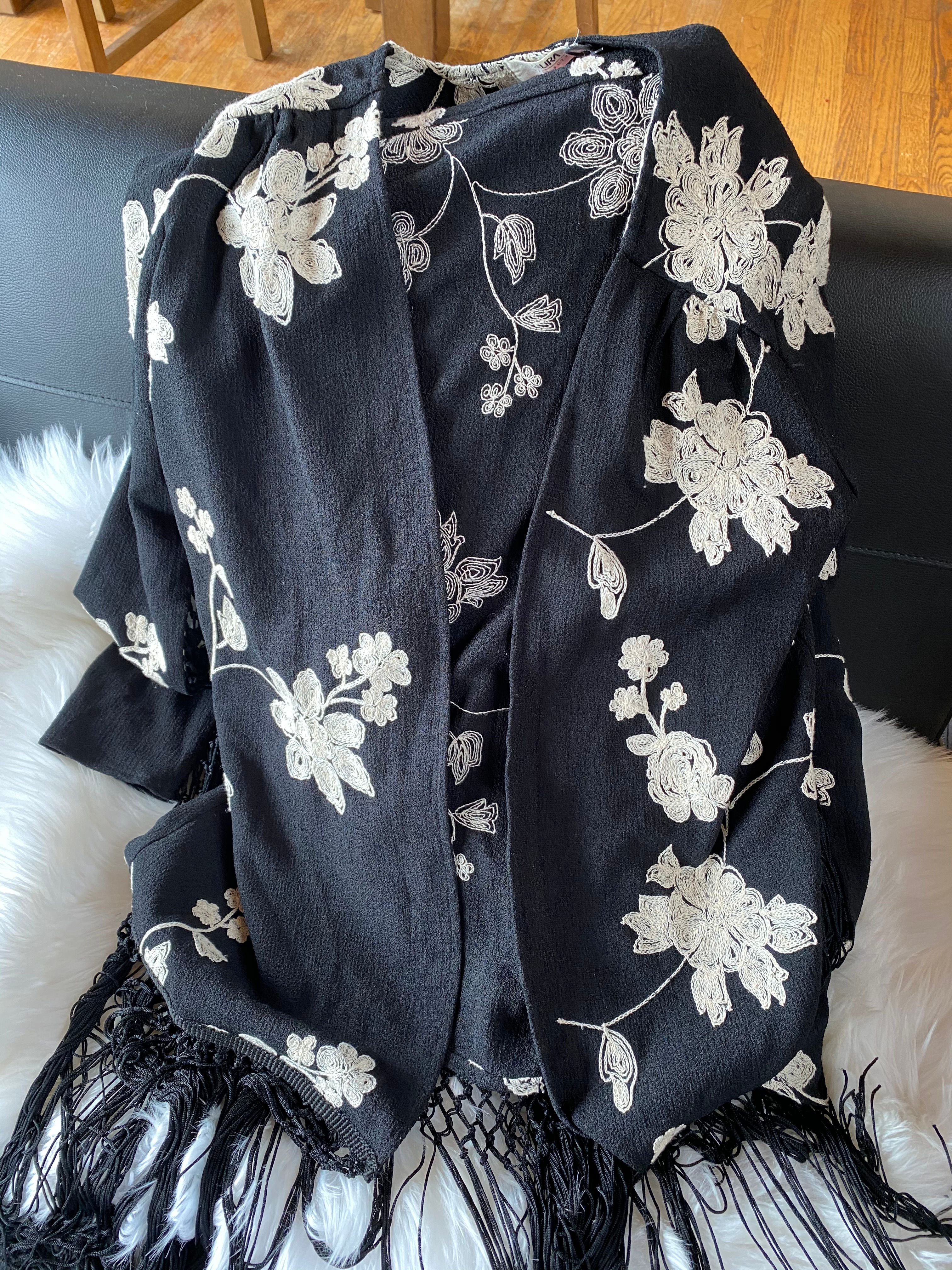 Black garment with white floral embroidery
